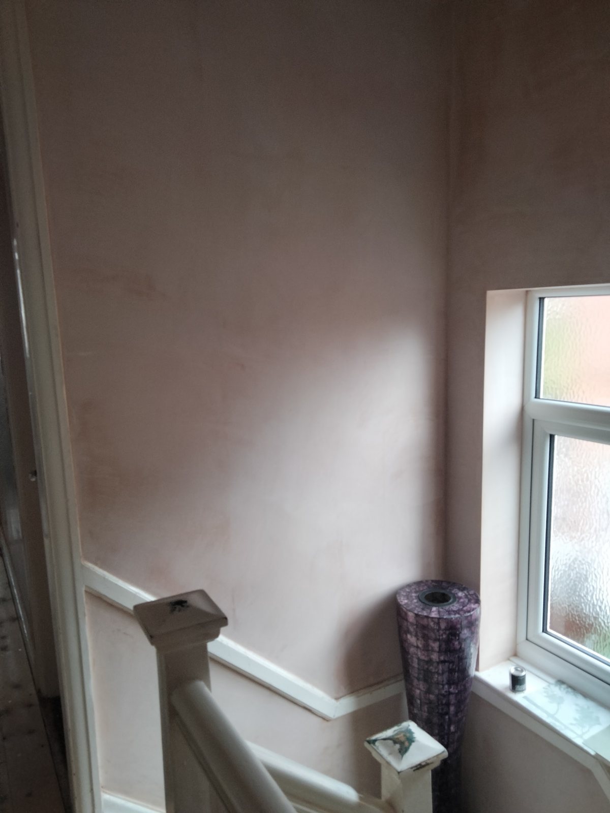 After: the same stairwell plastered smooth around the window